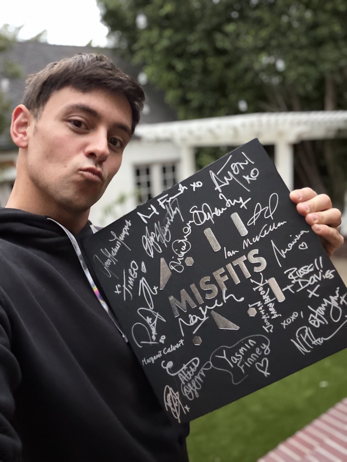 Tom Daley signing the Misfits Pride Edition